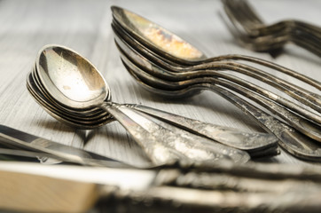 old cutlery on white wooden table