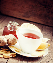 Ginger-lemon hot black tea with honey in a white porcelain dish,