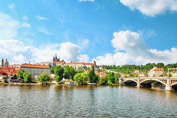 Obraz premium View of Prague Castle from waterfront- famous historic bridge th