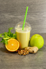 Apple, orange and celery fresh juice with ginger and walnuts.