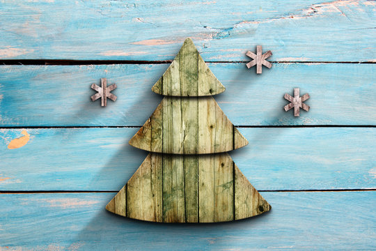 Wooden xmas tree on blue board