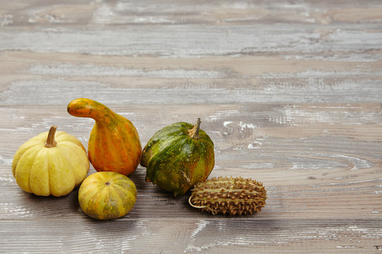Bunch of groceries: pumpkins, patison, squash,  on grunge wooden