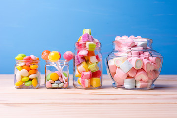 Colorful candy in jar on table