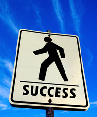 white pedestrian walking with success word sign in the blue sky