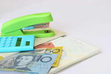 Calculator and stapler and Australian Dollar