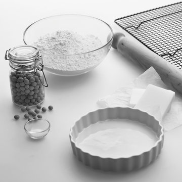 Plain pastry making ingredients and utensils on a kitchen worktop.