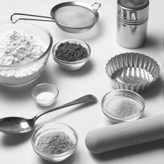 Home baking ingredients and utensils on a kitchen worktop.