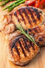 grilled pork chop with vegetable on wooden board