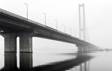 bridge over the river in the fog