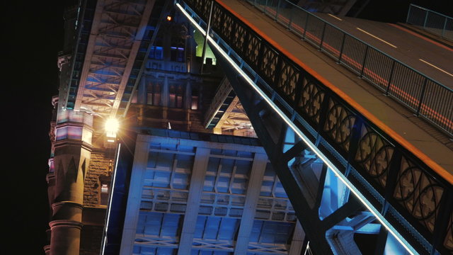 A night ultra close-up view of Tower Bridge's lifts opening. The Tower Bridge, often wrongly named as London Bridge, is one of the most famous landmarks in London
