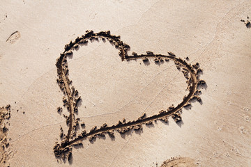 heart drawn in sand with copy space
