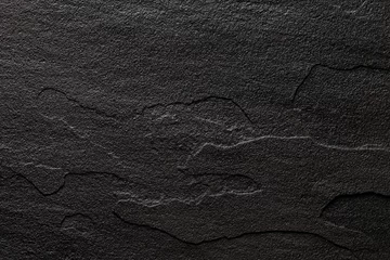 Fototapete Steine Reliefoberfläche aus dunklem Naturstein für den Hintergrund.