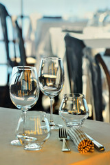 Wine glasses and dishes on the summer terrace of the restaurant