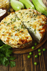 Casserole of pasta with green peas, zucchini and curd