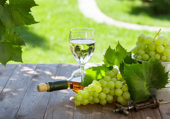 White wine bottle and glass with white grape