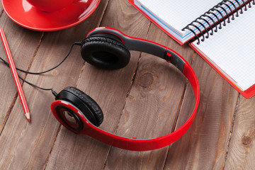 Desk with notepad, coffee and headphones