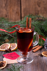 Mulled wine, sliced dried orange, cinnamon sticks, anise stars and candle with pine brunch