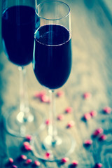Two glasses of champagne with pomegranate seeds