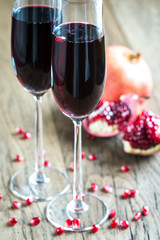 Two glasses of champagne with pomegranate seeds