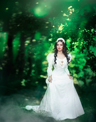 Wedding. Young beautiful bride with hairstyle and makeup posing in white dress