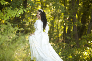 Obraz na płótnie Canvas Wedding. Young beautiful bride with hairstyle and makeup posing in white dress