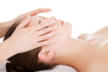 Relaxed woman enjoy receiving face massage