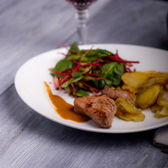 Veal steak with sauce and potatoes