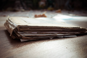 Old folder with stack of old papers