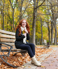 redhead girl portrait in city park, fall season