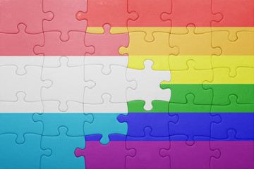 Fototapeta premium puzzle with the national flag of luxembourg and gay flag