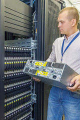IT Engineer installs JBOD  to rack in datacenter