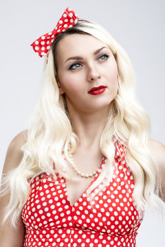 Fashion and Beaut Concept. Cheerful Caucasian Blond Female in Retro Style Dress