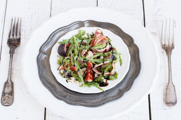 Salad with figs ,prosciutto , arugula and Parmesan cheese seasoned with balsamic sauce..selective focus