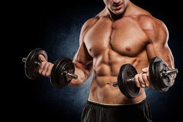 Fototapeta na wymiar Muscular bodybuilder guy doing exercises with dumbbells isolated