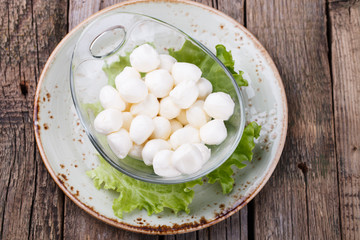 Round mini mozzarella in a glass bowl. selective focus