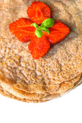 Stack of homemade healthy pancakes with strawberries on white  background.