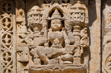 Stone relief with Hindu god on the front of indian temple