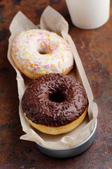 Two donuts on a rustic table