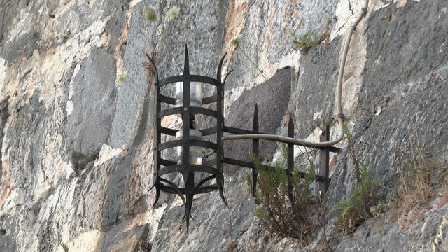 Stylized antique lamp on the wall of an ancient fortress. Kos Island, Greece.
