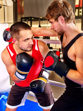 Two  men boxer wearing gloves boxing .