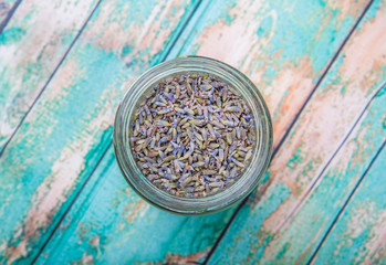 Dried lavender herbal tea in mason jar over wooden background