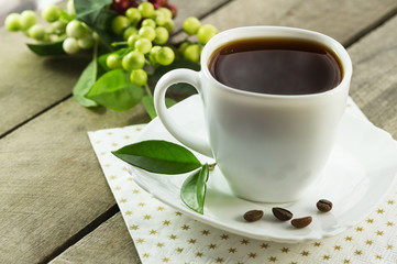 Black coffee in white cup and coffee beans