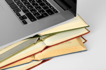 Stack of books with laptop close up
