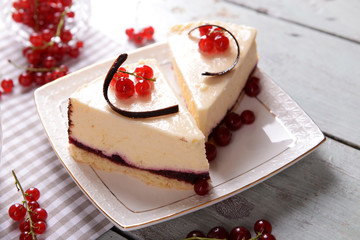 Tasty cheesecake with berries on table close up