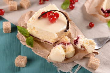 Tasty cheesecake with berries on table close up