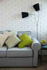 Beautiful modern living room with grey sofa and floor lamp