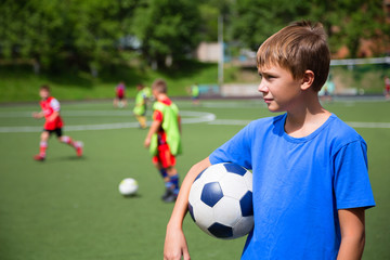 Children playing football in a stadium
