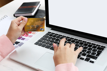 Concept for Internet shopping: hands with laptop and credit card