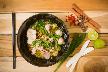 bowl of noodles with vegetables and soft boiled egg on wooden ta