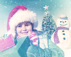 Happy Little Girl Holding Gifts And A Snowman Concept